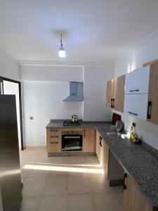 a kitchen with a sink and a stove at Best Appartement 3 BEDROOMS in Marrakech