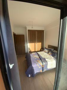 a bedroom with a bed and a large glass window at Best Appartement 3 BEDROOMS in Marrakech +15 photos