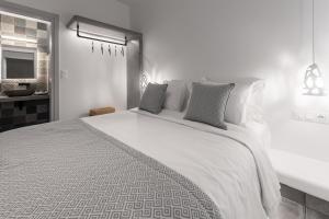 A bed or beds in a room at Manesis Suites