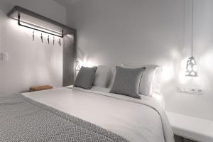 A bed or beds in a room at Manesis Suites