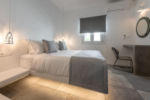 A bed or beds in a room at Manesis Suites