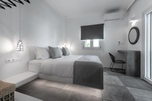A bed or beds in a room at Manesis Suites