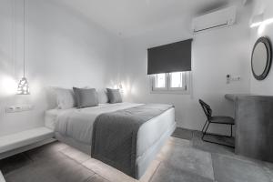 A bed or beds in a room at Manesis Suites