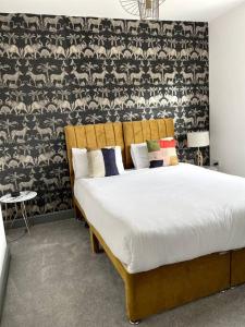 a bedroom with a bed with a black and white wallpaper at Luxury 2 Bed Duplex Apartment by YO ROOM! - Leicester City- Free Parking in Leicester