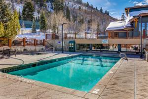 a swimming pool in front of a house with a mountain at The Lodges at Deer Valley-A - #5323 in Park City