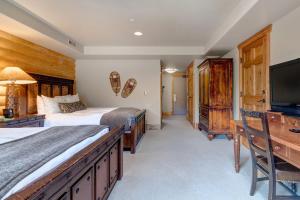 a bedroom with two beds and a flat screen tv at The Lodges at Deer Valley-B - #5325 in Park City
