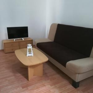 a living room with a couch and a coffee table at Apartments with a parking space Seget Vranjica, Trogir - 5966 in Seget Vranjica