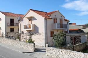 a house on the side of a street at Apartments with parking space Supetar, Brac - 6037 in Supetar