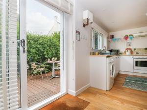 a kitchen with a sliding glass door leading to a patio at Bolitho's Retreat in Saint Martins Green