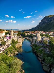 an aerial view of a town with a bridge over a river at Jacuzzi Sauna SelfCheckIn Mystic in Mostar