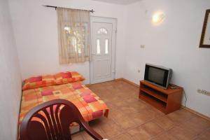 a bedroom with a bed and a tv on a table at Apartments with a parking space Podaca, Makarska - 6050 in Podaca