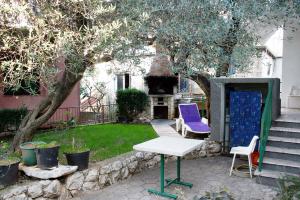 a table and two chairs sitting in a yard at Apartments with parking space Podaca, Makarska - 6055 in Podaca