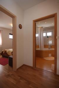 a room with a bathroom with a tub and a mirror at Apartments and rooms by the sea Vodice - 6182 in Vodice