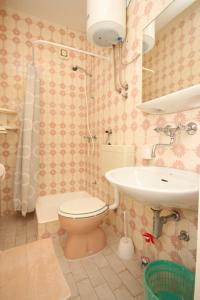 a bathroom with a toilet and a sink at Apartments and rooms by the sea Vodice - 6182 in Vodice