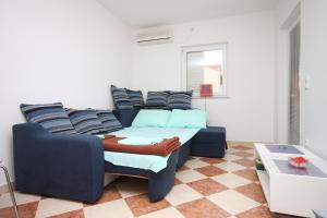 a living room with a couch and a table at Apartments with a parking space Vodice - 6183 in Vodice