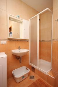 a bathroom with a shower and a sink and a toilet at Apartments with a parking space Vodice - 6183 in Vodice