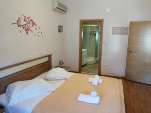 a bedroom with a bed with two towels on it at Apartments by the sea Nin, Zadar - 6125 in Nin