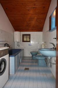 a bathroom with two toilets and a sink and a washing machine at Apartments with a parking space Grebastica, Sibenik - 6103 in Grebaštica