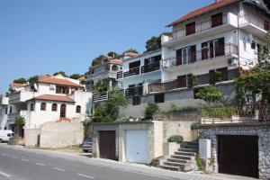an apartment building on the side of a street at Apartments by the sea Tisno, Murter - 6106 in Tisno