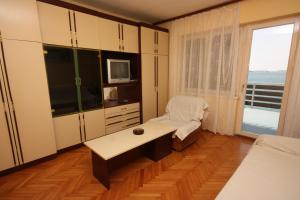 a room with a desk in a room with a window at Apartments by the sea Tisno, Murter - 6106 in Tisno