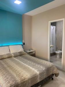 een slaapkamer met een bed en een badkamer met een toilet bij Pia II in Salta