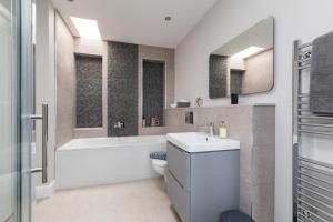 a bathroom with a toilet and a tub and a sink at Caddyshacks Gullane, 4 bedroom, 4 bath, Golf, Beach in Gullane