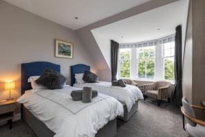 a bedroom with two beds and a window at Caddyshacks Gullane, 4 bedroom, 4 bath, Golf, Beach in Gullane