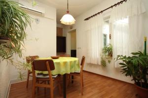 a dining room with a yellow table and chairs at Apartments with WiFi Rabac, Labin - 7472 in Rabac