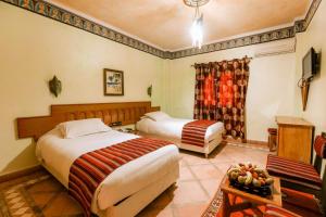 Hotel Kasbah Lamrani客房内的一张或多张床位