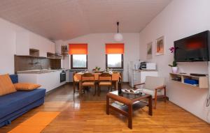 a living room with a blue couch and a table at Apartments with parking space Manjadvorci, Marcana - 7445 in Barban