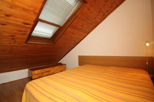 a bedroom with a bed with a wooden ceiling at Apartments with a parking space Premantura, Medulin - 7443 in Premantura