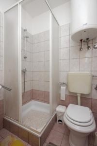 a bathroom with a shower and a toilet and a sink at Apartments by the sea Duga Luka - Prtlog, Labin - 7491 in Labin