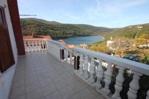 a balcony with a view of a body of water at Apartments by the sea Duga Luka - Prtlog, Labin - 7491 in Labin
