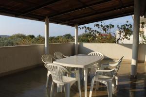 a table and chairs on a balcony with a view at Apartment Banjole 7487a in Banjole