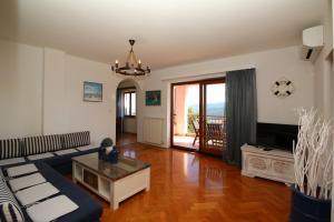 a living room with a couch and a table at Apartment Rabac 7429a in Rabac