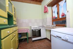 a small kitchen with a stove and a sink at Family friendly house with a parking space Bibici, Central Istria - Sredisnja Istra - 7412 in Bibići +14 photos