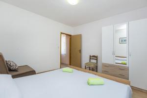 a bedroom with a bed and a living room at Apartment Vinez 7471a in Labin