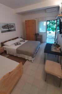 a bedroom with two beds and a table and a desk at Apartments by the sea Seget Vranjica, Trogir - 7508 in Seget Vranjica