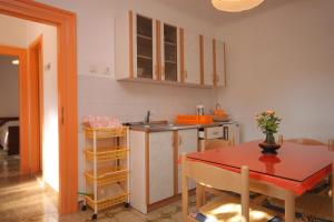 a kitchen with a table and a dining room at Apartments with a parking space Valtura, Pula - 7419 in Valtura