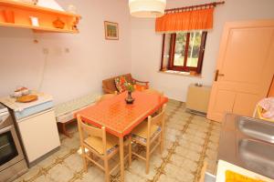 a kitchen and dining room with a table and chairs at Apartments with a parking space Valtura, Pula - 7419 in Valtura