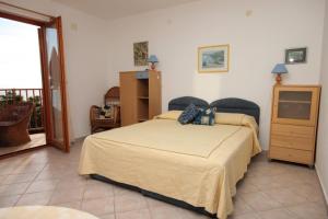 a bedroom with a large bed and a balcony at Apartments with a parking space Ravni, Labin - 7450 in Ravni