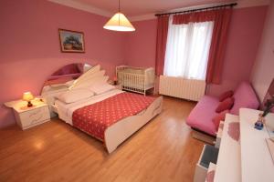 a bedroom with a bed and a couch at Apartments with a parking space Funtana, Porec - 7414 in Funtana