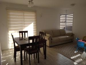 a living room with a table and chairs and a couch at Hospedaje el Rosario in Angol