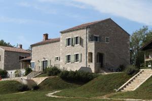 an old stone house with a staircase in front of it at Luxury villa with a swimming pool Skrapi, Central Istria - Sredisnja Istra - 7525 in Brajkovići
