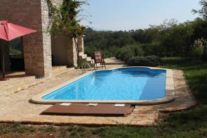 a swimming pool in the backyard of a house at Luxury villa with a swimming pool Skrapi, Central Istria - Sredisnja Istra - 7524 in Brajkovići