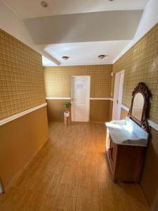 a bathroom with a sink and a mirror in a room at OLO Hostel in Santa Fe