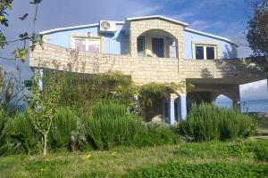 an old brick house on top of a field at Apartments with a swimming pool Podgradina, Novigrad - 6198 in Posedarje