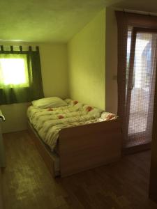 a bedroom with a bed in a room with a window at Apartments with a swimming pool Podgradina, Novigrad - 6198 in Posedarje