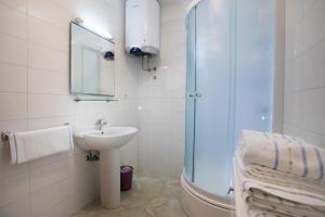 a bathroom with a sink and a glass shower at Apartments by the sea Razanj, Rogoznica - 7484 in Ražanj