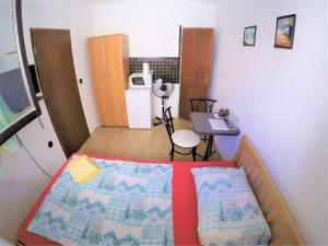 a small bedroom with a bed and a desk at Apartments and rooms by the sea Bibinje, Zadar - 6199 in Bibinje